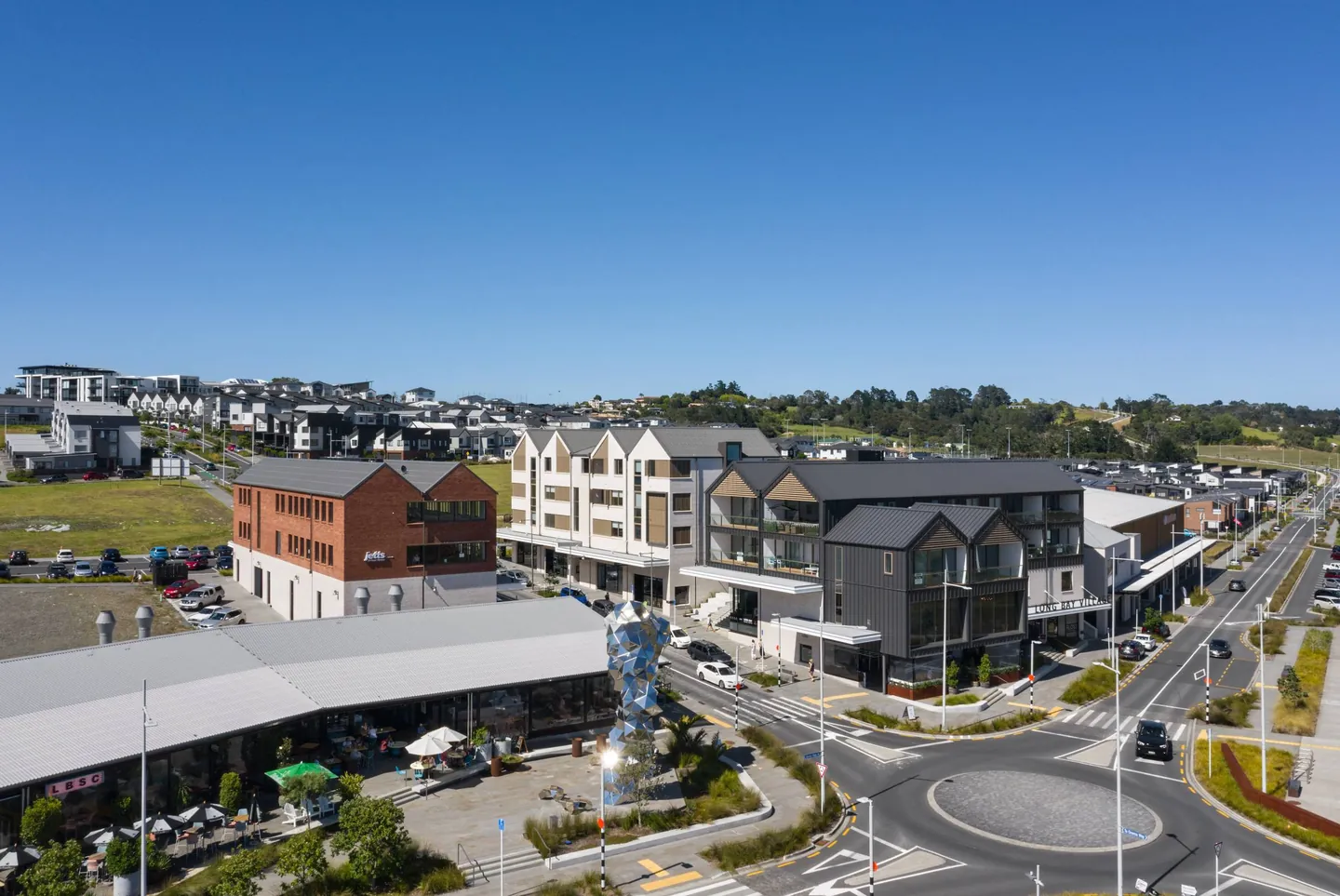 Elevated view of completed Long Bay Village buildings, shops and public square.
